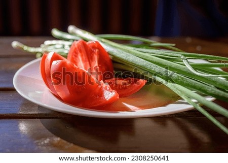close-up of a plate of fresh raw vegetables on a wooden table.