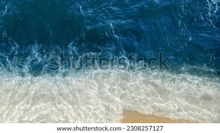 Bird's-eye view of ocean waves. Blue water background, wide banner.