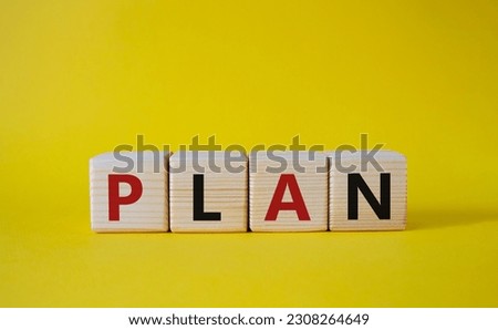 Plan symbol. Concept word Plan on wooden cubes. Beautiful yellow background. Business and Plan concept. Copy space.