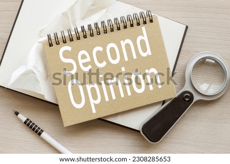 Second Opinion white font on a craft notepad. magnifier and wood background Royalty-Free Stock Photo #2308285653