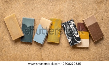 variety of 7 organic, artisan soap bars on a textured bark paper Royalty-Free Stock Photo #2308292535