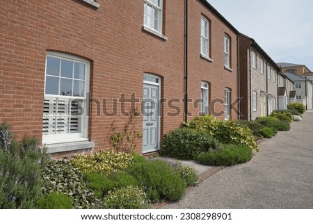 Exterior view of beautiful old red brick houses on a street in an English town
