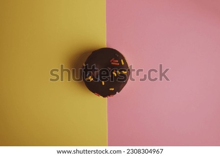 Donuts pattern. Top view. Colorful donuts with icing as background with copy space. Colorful glazed doughnuts with sprinkles.