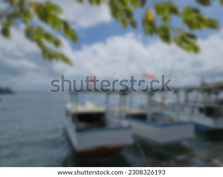 Blurry background, fishing boats anchored on the beach 