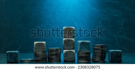 stacks of coins and stones on dark gray blue background for podium banner background