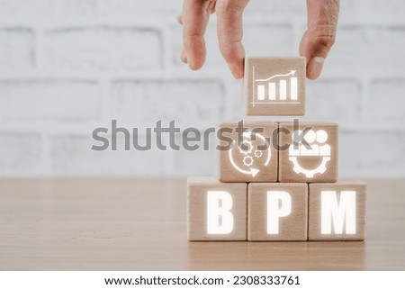 BPM, Business Process Management concept, Hand holding wooden block with business process management icon on virtual screen.