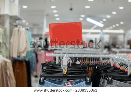 selective focus to blank red board for women's and men's clothing discount template in mall. soft focus Royalty-Free Stock Photo #2308335361