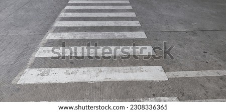 a picture of a zebra crossing in the middle of the road 