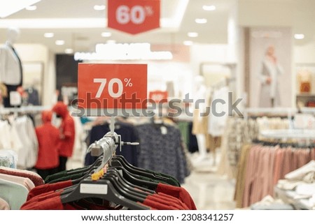 selective focus to red discount board with 70% writing. for discount templates for women's and men's clothing at the mall. soft focus