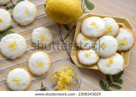 Lemon cookies on a grill with icing and fresh lemon zest 
