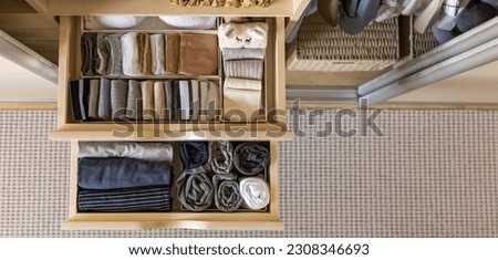 Modern wardrobe with stylish women's clothing. Drawer with underwear, t-shirts, socks and shorts. The concept of storage and order. Top view. Royalty-Free Stock Photo #2308346693