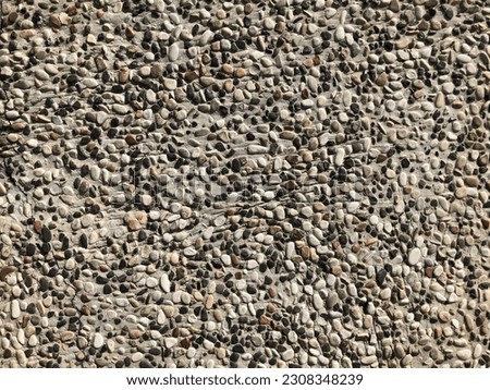 Light gray gravel wall wide texture. White washed pebble dash panoramic background