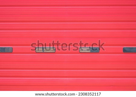 A roll-down firehouse garage door background with space for copy Royalty-Free Stock Photo #2308352117