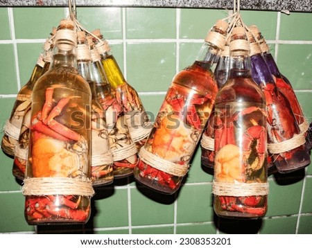 Transparent bottles filled with cachaça, spiced with crabs, for sale to tourists in the São Luís market, Maranhão, Brazil. Royalty-Free Stock Photo #2308353201