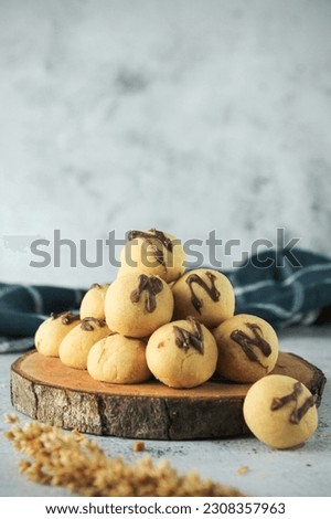 cake ball with chocolate on topping. indonesian cake or cookies. served on wooden place map in grey and texture background