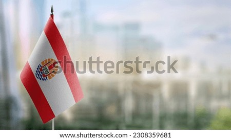 A small French Polynesia flag on an abstract blurry background. Royalty-Free Stock Photo #2308359681