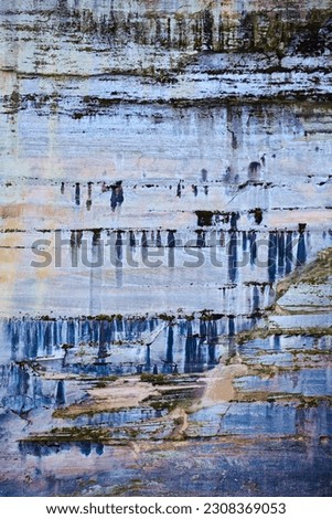 Background Pictured Rocks with minerals dripping like paint down stone cliff wall
