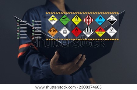 Customs warehouse staff holding clipboard documents check list inspect dangerous goods store in the warehouse waiting to be transport or distribute to the production process. dangerous goods concept. Royalty-Free Stock Photo #2308374605