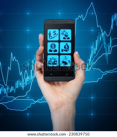 A hand holding a smartphone with business icons over the forex background.