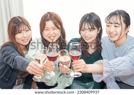 Four women toasting with wine                            