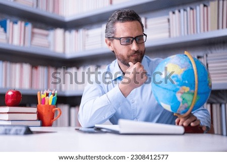 Teacher in classroom. Knowledge and education with handsome teacher. Teacher with book in classroom. Man on lesson in class. Teachers from university exam. College teacher. Teaching and learning. Royalty-Free Stock Photo #2308412577