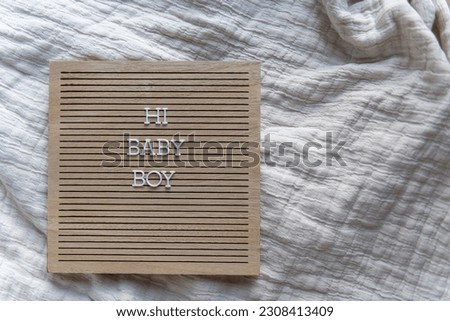 Hi baby boy wooden brown letter board with white letters neutral beige baby announcement