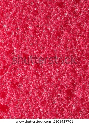 close-up, background, texture, large vertical banner. heterogeneous surface fine pore structure bright saturated red pumice stone for finger care. full depth of field. high resolution photo