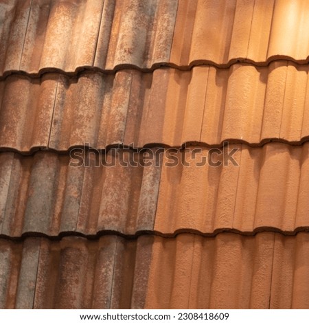Comparison tiles roof top before and after cleaning moss lichen with brush Royalty-Free Stock Photo #2308418609
