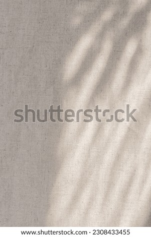Elegant neutral beige pastel summer boho wedding background, linen textile texture with an abstract sun light shadows