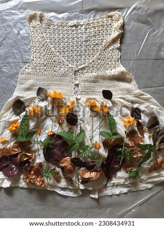 Layout pattern design with botanical material on vintage cotton dress