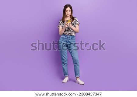 Full size photo of charming girl hold use smart phone chatting write blog post isolated on violet color background