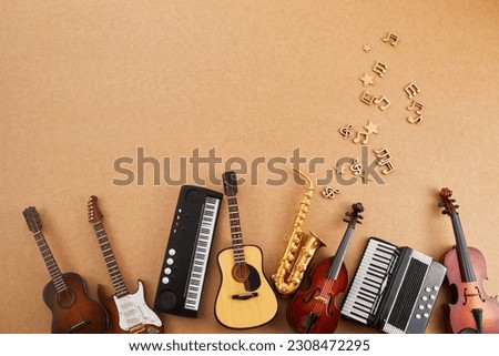 Happy world music day. Musical instruments on brown background. Royalty-Free Stock Photo #2308472295