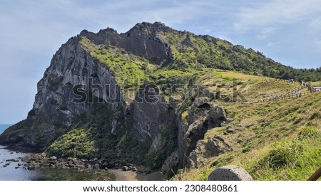 It is Seongsan Ilchulbong Peak in Jeju Island. It is a wonderful view that harmonizes with the sea with beautiful natural scenery. Have a nice picture of Seongsan Ilchulbong in Jeju Island.