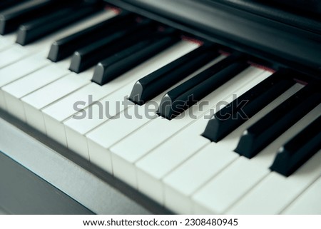 A man pianist wearing white suit and black plant perform piano classical song in close up shot with copy space . playing piano with confident. 