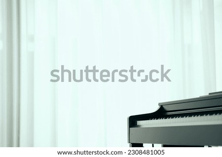 A man pianist wearing white suit and black plant perform piano classical song in close up shot with copy space . playing piano with confident. 
