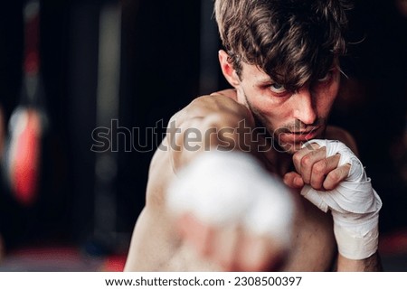 Boxer training in Boxing Club. Boxing fighters training at gym. Strong muscular Man practicing box in gym.