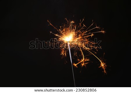 New year party sparkler on black background Royalty-Free Stock Photo #230852806