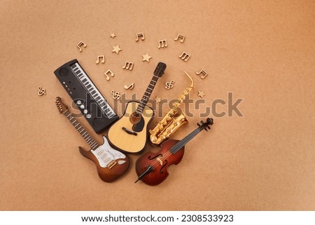 Happy world music day. Musical instruments on brown background. Royalty-Free Stock Photo #2308533923