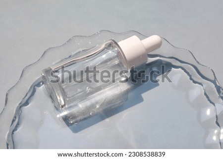 A bottle of serum in water on a blue background.