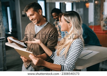 Business solutions, technology and strategy concept. Colleagues working and brainstorming in office Royalty-Free Stock Photo #2308540173