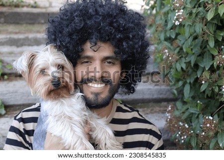 A handsome ethnic man and his Yorkshire Terrier 