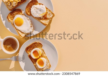 fried Toast bread with four different types of cooked chicken eggs, scrambled eggs, fried eggs, poached egg and creamed egg. Breakfast of chicken eggs. Royalty-Free Stock Photo #2308547869