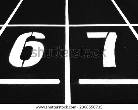 Stadium runway or athlete's track start number (6) (7). Tracks are rubber man-made tracks used in athletics.(Black and white photo)