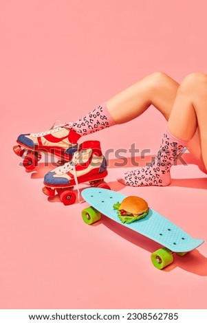 Female legs in vintage rollers and funny socks with delicious burger on skateboard against pink background. Delivery. Concept of pop art photography, creative vision, imagination. Minimal art