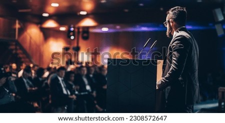 Speaker giving a talk on corporate business conference. Unrecognizable people in audience at conference hall. Business and Entrepreneurship event. Royalty-Free Stock Photo #2308572647