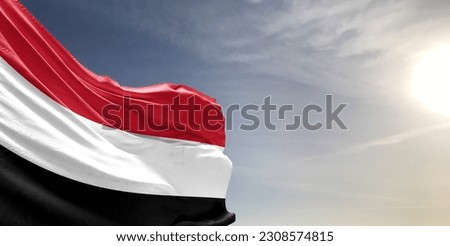 Yemen national flag cloth fabric waving on beautiful grey Background. Royalty-Free Stock Photo #2308574815