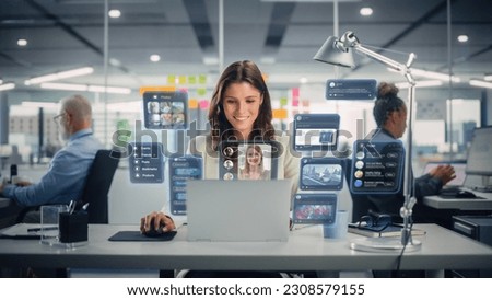 Young Businesswoman Using Laptop Computer in Office with Colleagues. Stylish Social Media Manager Smiling, Working Online Marketing Projects. VFX Hologram Edit Visualizing Social Network With Friends.