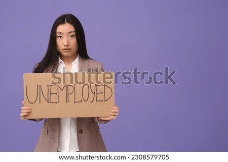 Asian woman holding sign with word Unemployed on purple background. Space for text