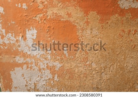 RUSTIC TERRACOTTA FLAKY PAINT BACKGROUND - Aged old worn flaking painted rough textured, ceramic red rusty orange earthy colored, detailed solid flat wall plastered background              Royalty-Free Stock Photo #2308580391