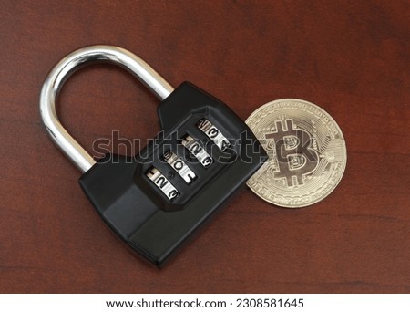 Cryptocurrency safety in 2023 concept. Padlock with numbers 2023 on bitcoin close up. 